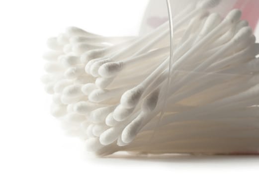 White cotton swabs in plastic container