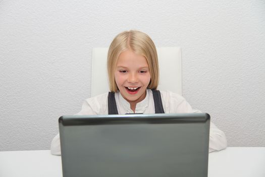 Young Girl Using Laptop At Home