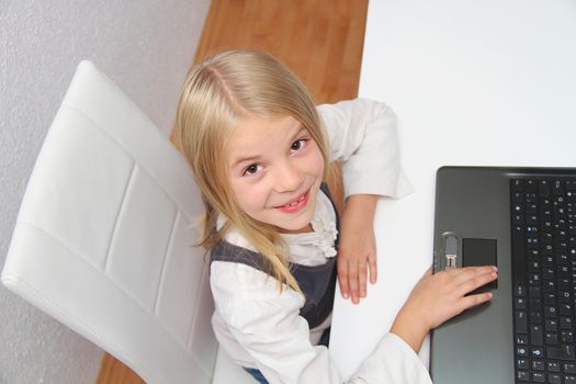 Young Girl Using Laptop At Home