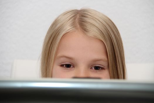 Young Girl Using Laptop At Home