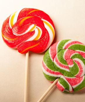 Bright lollipop candy on paper background