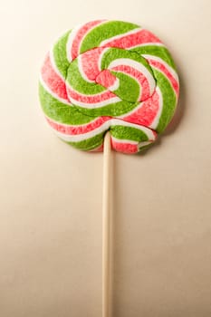 Bright lollipop candy on paper background