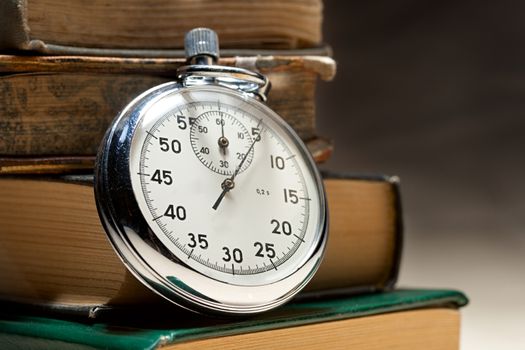 Pile of old books and stopwatch