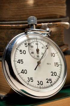 Pile of old books and stopwatch