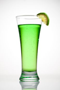 Green cocktail with a slice of lime