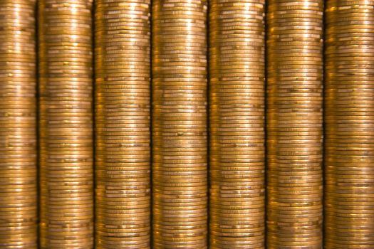 golden piles of coins stacked on one another