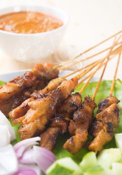 Chicken sate or satay, skewered and grilled meat, served with peanut sauce. Fresh cooked with steamed and smoke. Delicious hot and spicy Asian dish. 