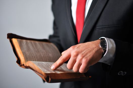 Businessman in a suit holding a book