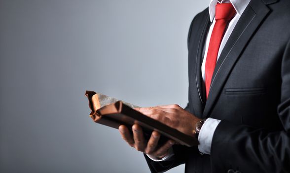 Businessman in a suit holding a book