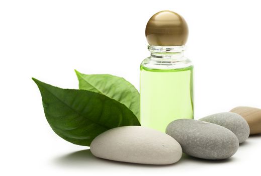 Shampoo bottle with stones and green leaves 