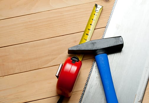 Handsaw, tape measure and hammer