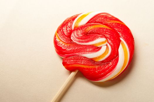 Bright lollipop candy on paper background