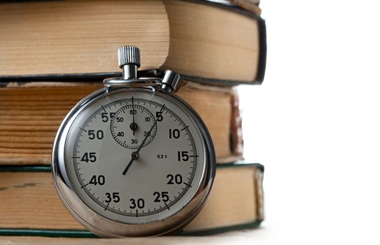 Pile of old books and stopwatch