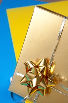 Decorated gift box on blue and yellow paper