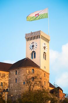 Clock tower of Ljubljana castle with town flag. Slovenia, Europe.
