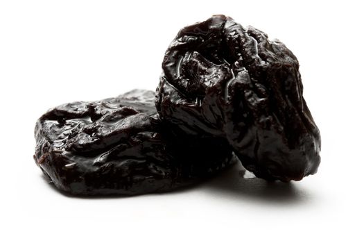 Prunes on the white background