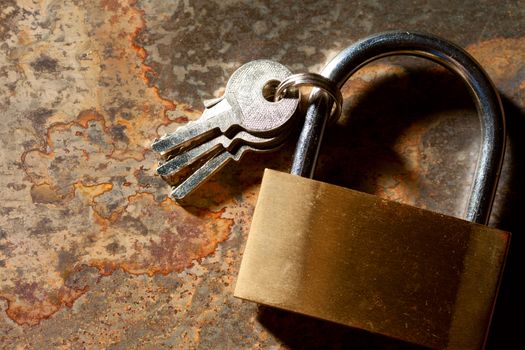 Lock with keys on the rusty background