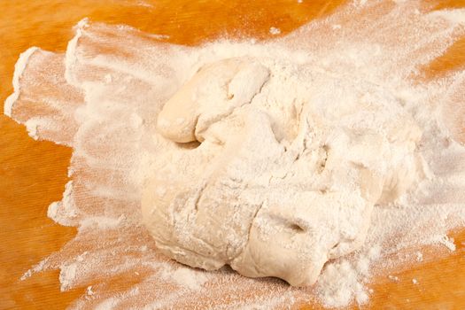 Dough in flour on breadboard