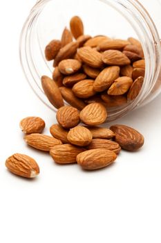 Almonds in the plastic jar on white 