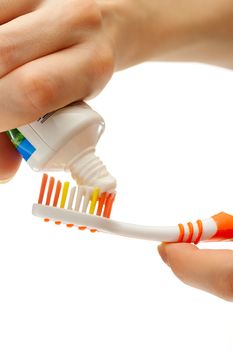 Toothbrush and toothpaste in female hands 