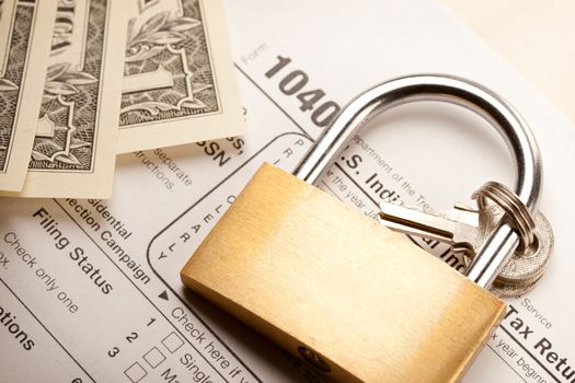 Tax form, dollars and key lock 