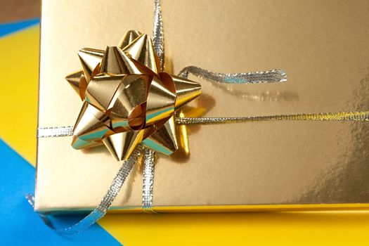 Decorated gift box on blue and yellow paper