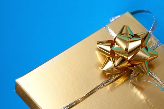 Decorated gift box on the blue background