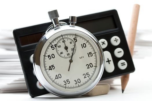 Pile of paper cards, calculator and stopwatch