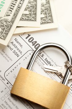 Tax form, dollars and key lock 