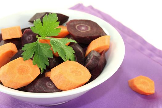 orange and purple carrots on a light background