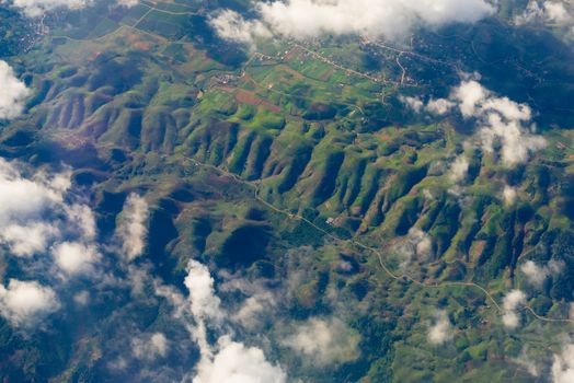 The View from the plane window above the cloud see mountain range when landing