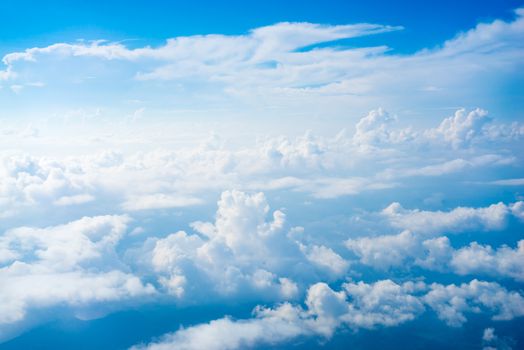 The View from the plane window above the cloud and blue sky