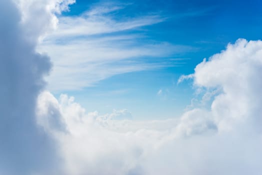 The View from the plane window above the cloud and blue sky