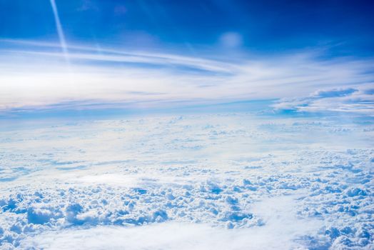 The View from the plane window above the cloud and blue sky