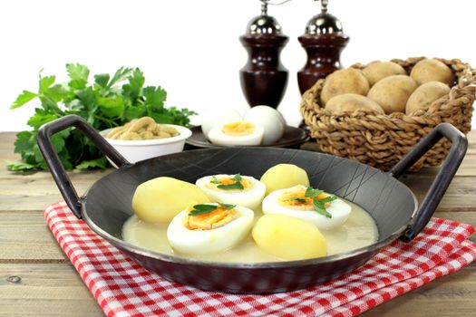 a pan with mustard eggs and potatoes