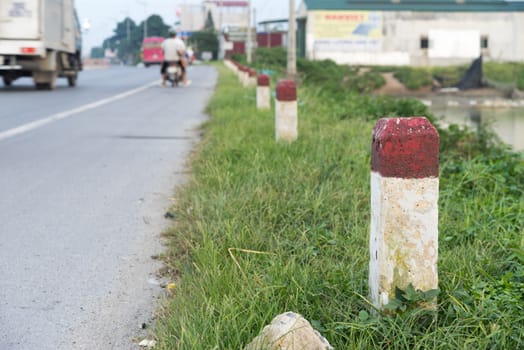 Poles lined along the road, red and white color