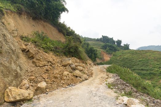 Rock fall into below of Mountainside beside abandon road