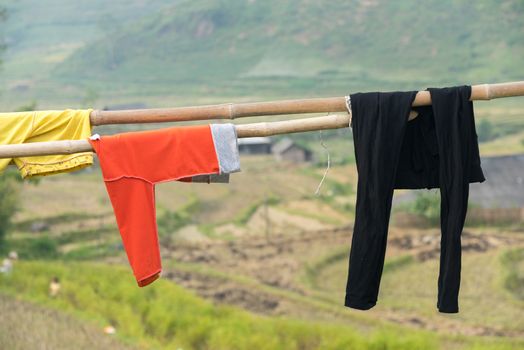 Drying clothes on the Mountain hanging on bamboo exposed to sun light