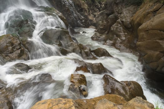 Waterfall flows continuously down the mountain.