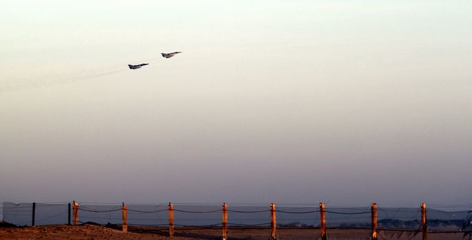 lift off two fighter jets over beach near sunset