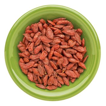 dried goji berries on an isolated green ceramic bowl - superfood abstract