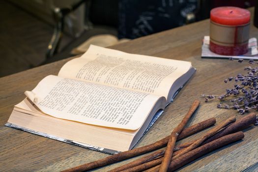 Close up of open book on wooden table