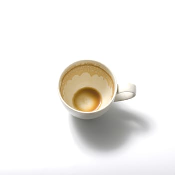 top view empty and dirty cup of coffee on a white background