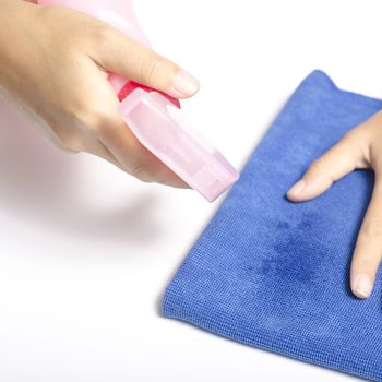two woman hands cleaning with spray bottle and blue rag on a white background