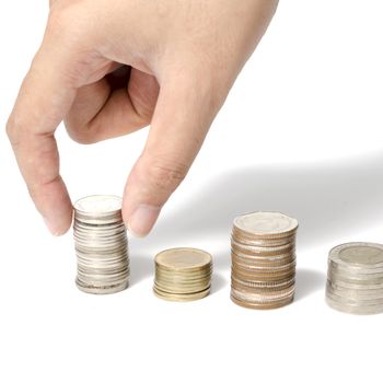 woman hand putting stack of coins on a white background