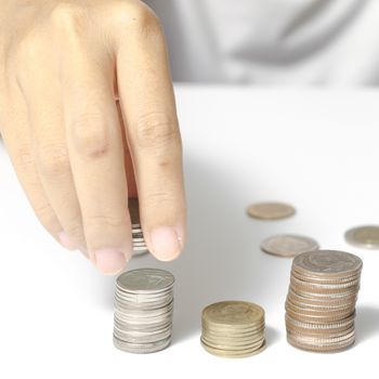 woman hand putting stack of coins