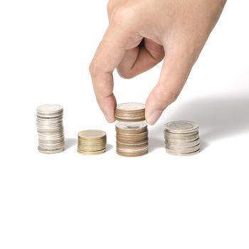 woman hand putting stack of coins on a white background
