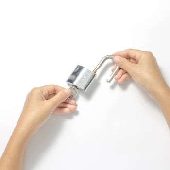 two woman hands open padlock with key on a white background