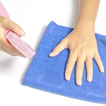 two woman hands cleaning with spray bottle and blue rag on a white background