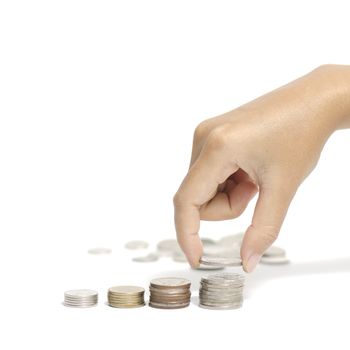 woman hand putting stack of coins on a white background